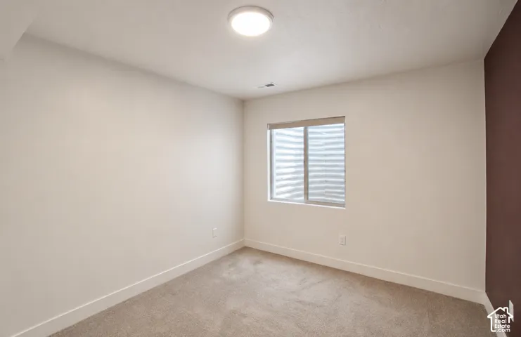 Recessed window with privacy blind, plush carpeting, contemporary ceiling light fixture, and two-tone wall finishes