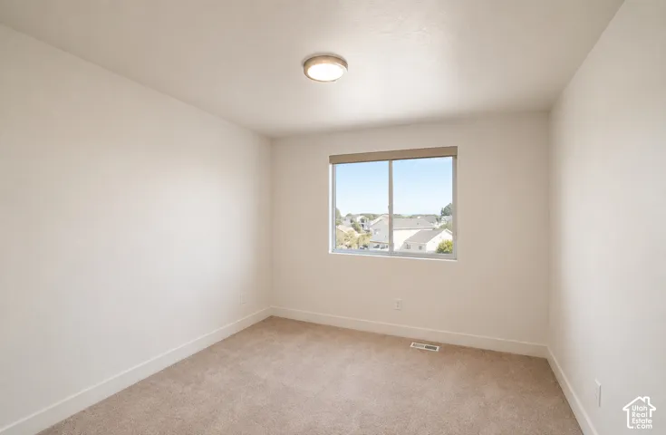 Neutral wall color, carpet flooring, recessed window, flush-mount ceiling light