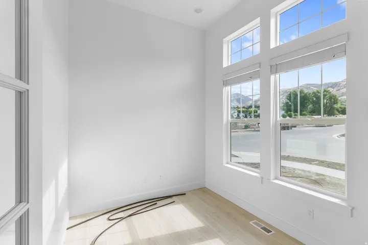 Vaulted ceiling, recessed lighting, wood-finish flooring, multiple windows, window coverings