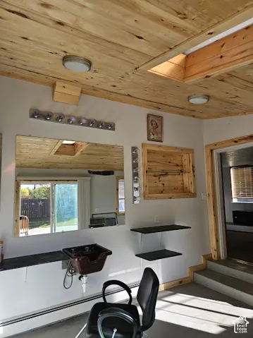 Wood-paneled ceiling with recessed lighting and a skylight