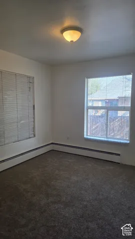 Bedroom with neutral wall color with textured carpeting
