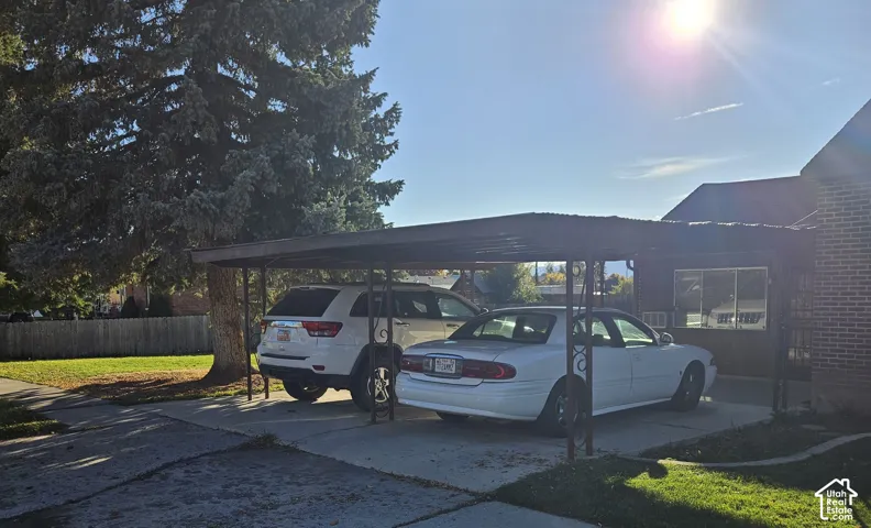 Two-car carport with a paved driveway