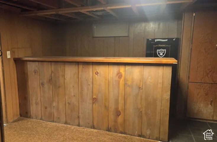 Wood-paneled built-in bar with a finished countertop