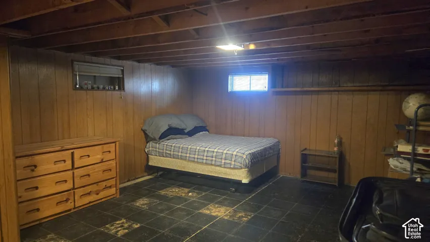 Paneled walls, exposed ceiling joists, and tiled flooring