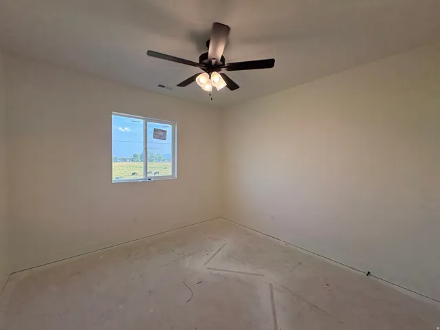 Recessed window, ceiling fan with integrated lighting, neutral wall finish, and un-finished floor