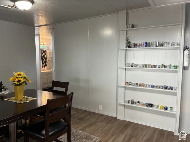 Wood-finish flooring with light gray walls and a built-in shelving unit