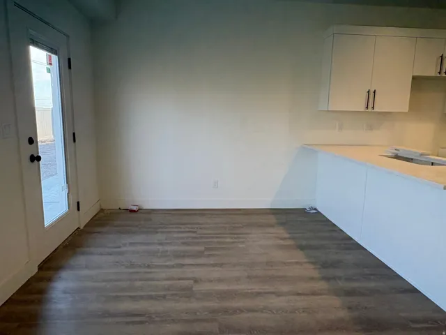 Wood-finish flooring with white baseboards