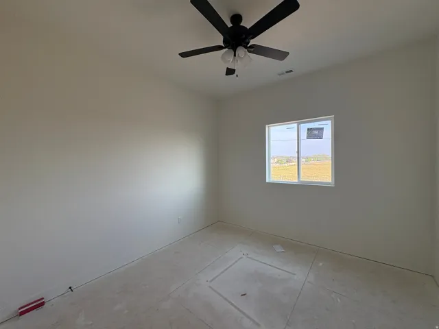 Room with a ceiling fan, a window, and light-colored walls