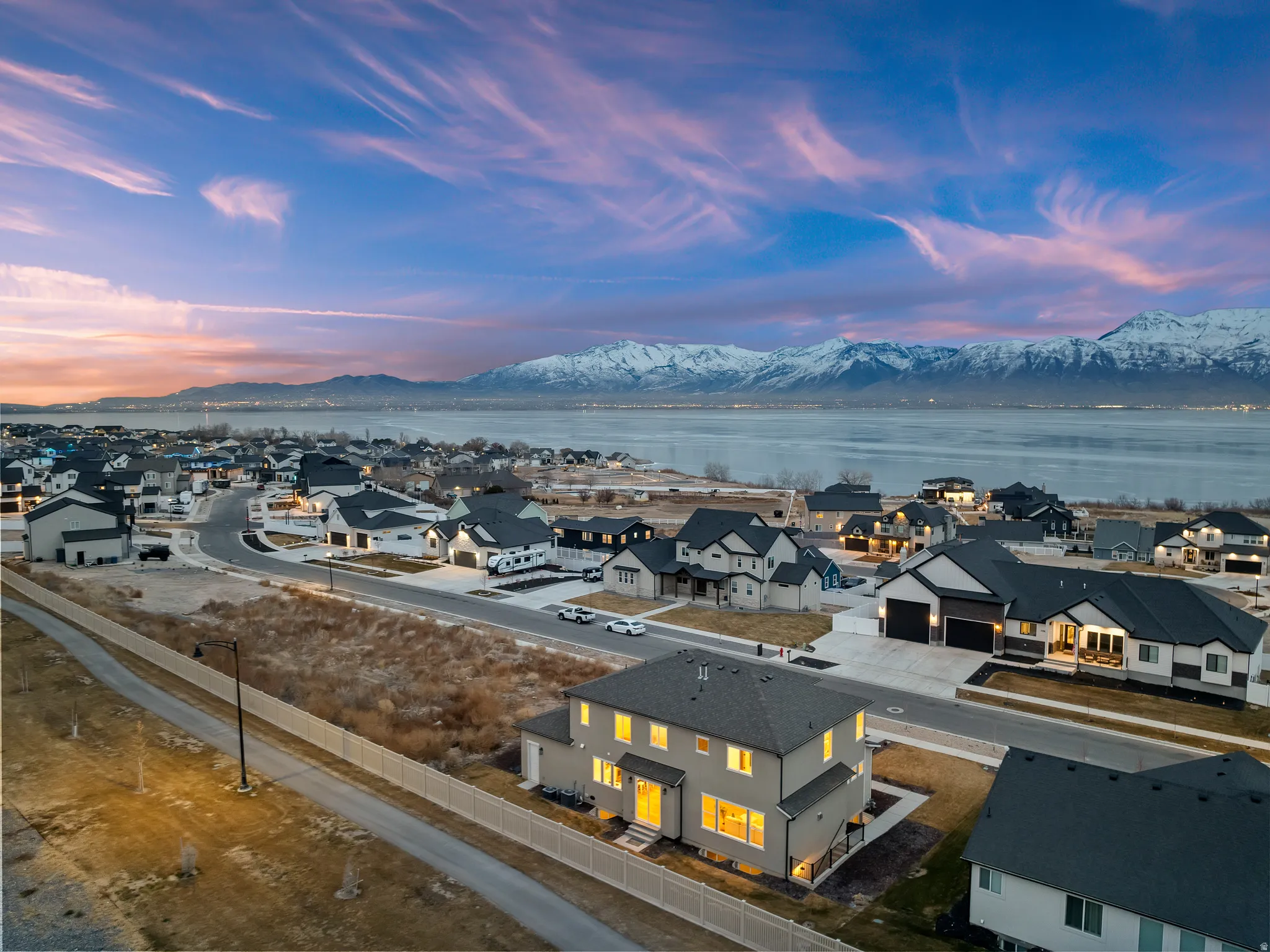 Modern residential community overlooking expansive water and mountain scenery