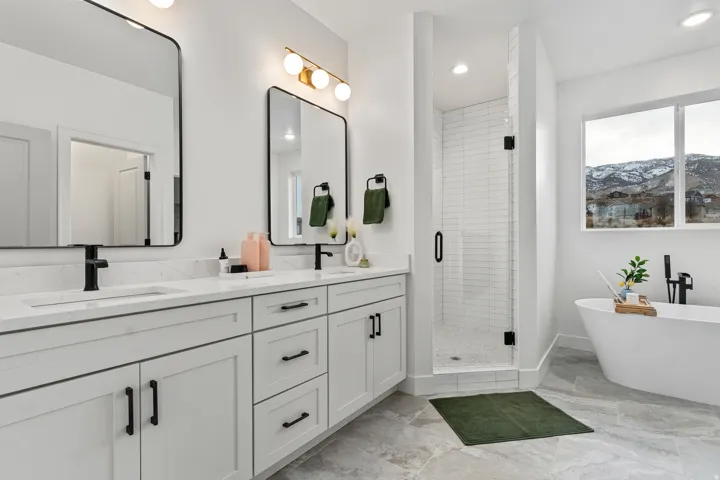 Dual vanity featuring white cabinetry, quartz countertops, and matte black fixtures