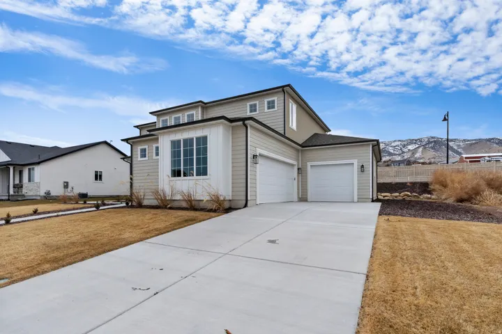 Contemporary exterior with light-colored siding and dark trim