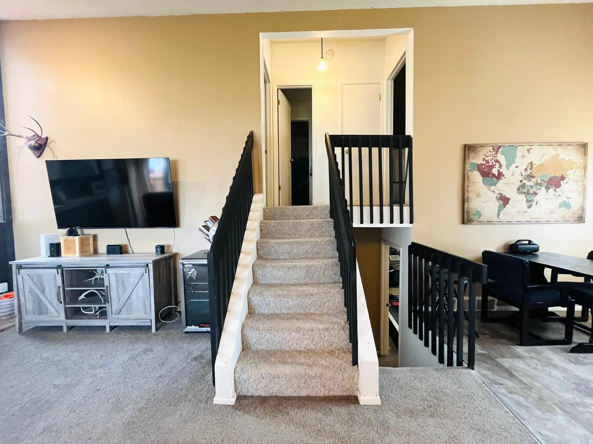 Open staircase featuring a modern black railing.
