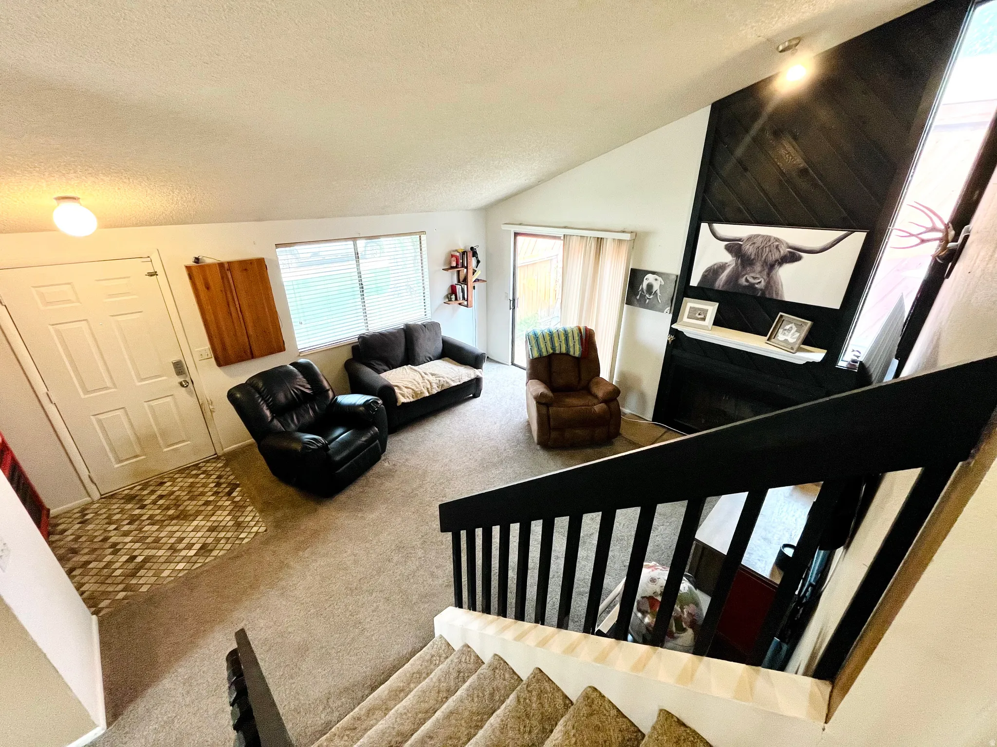 Inviting formal living room with soaring vaulted ceilings and gas fireplace.