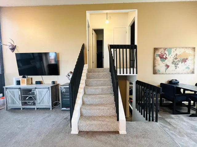 Open staircase featuring a modern black railing.