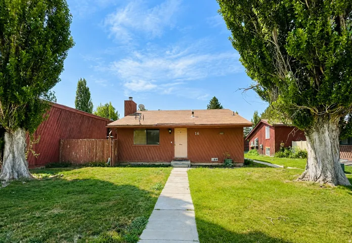 Front exterior with your own street access, a spacious yard, mature trees, and cedar siding.