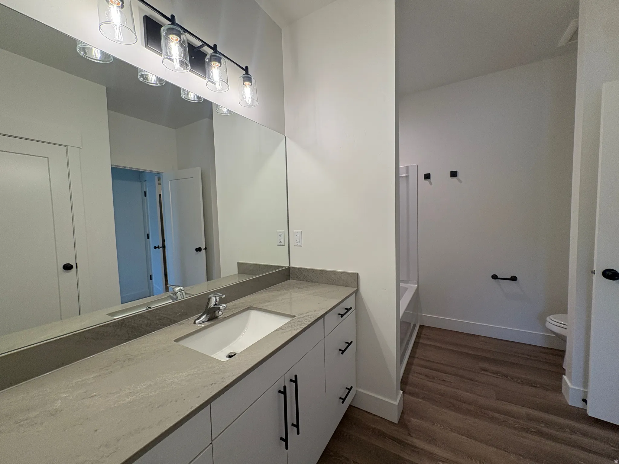 Vanity with an integrated sink and gray stone-finish countertop
