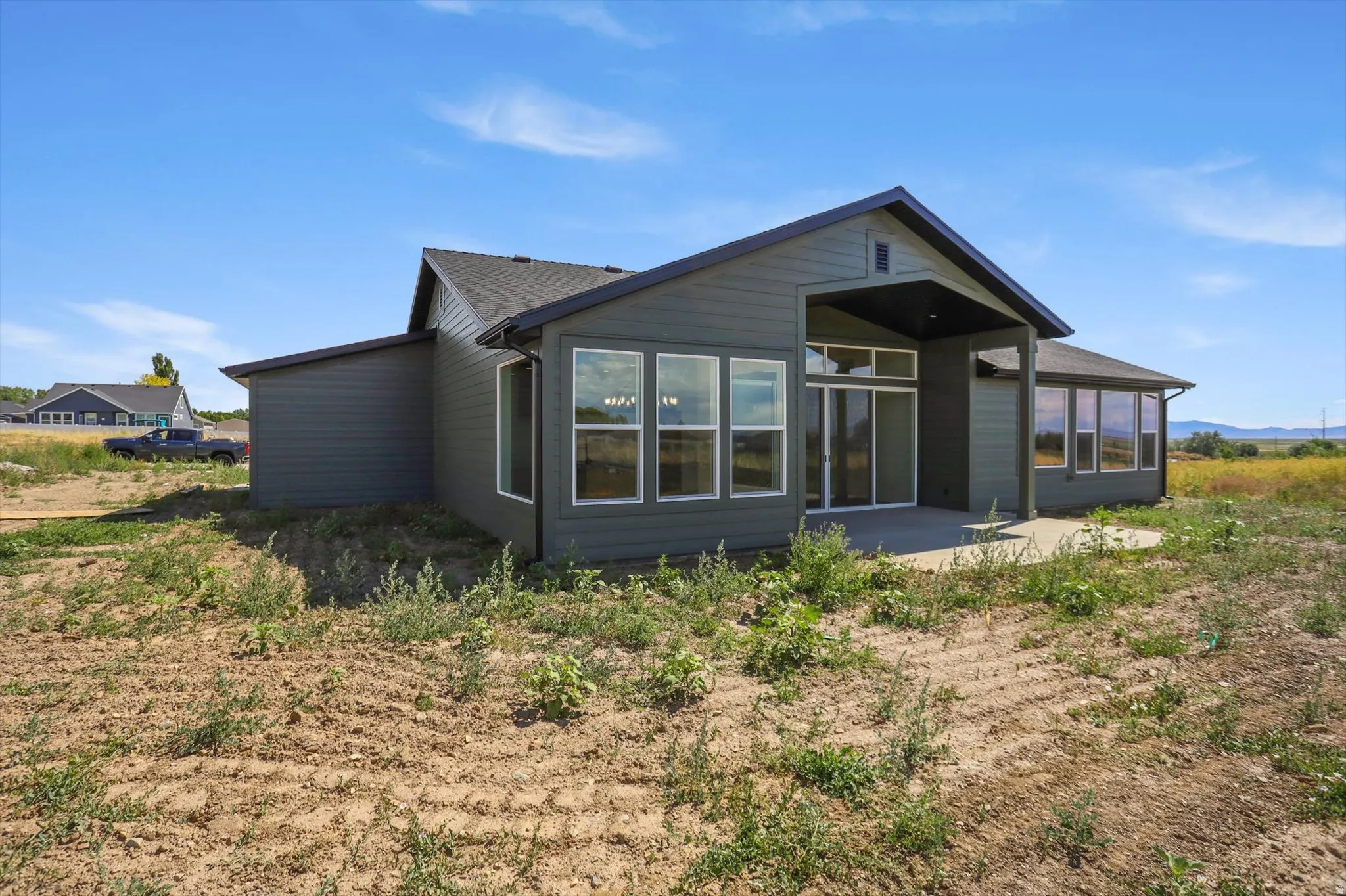 Dark gray siding exterior with a black shingle roof