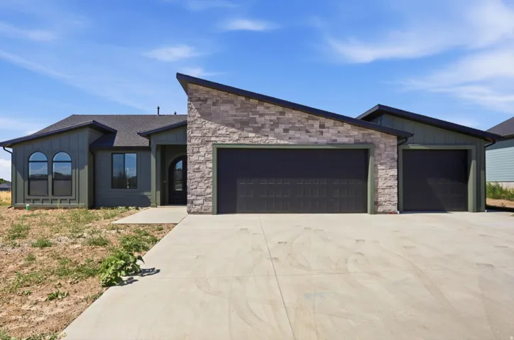 Contemporary exterior with board and batten siding and stone accents