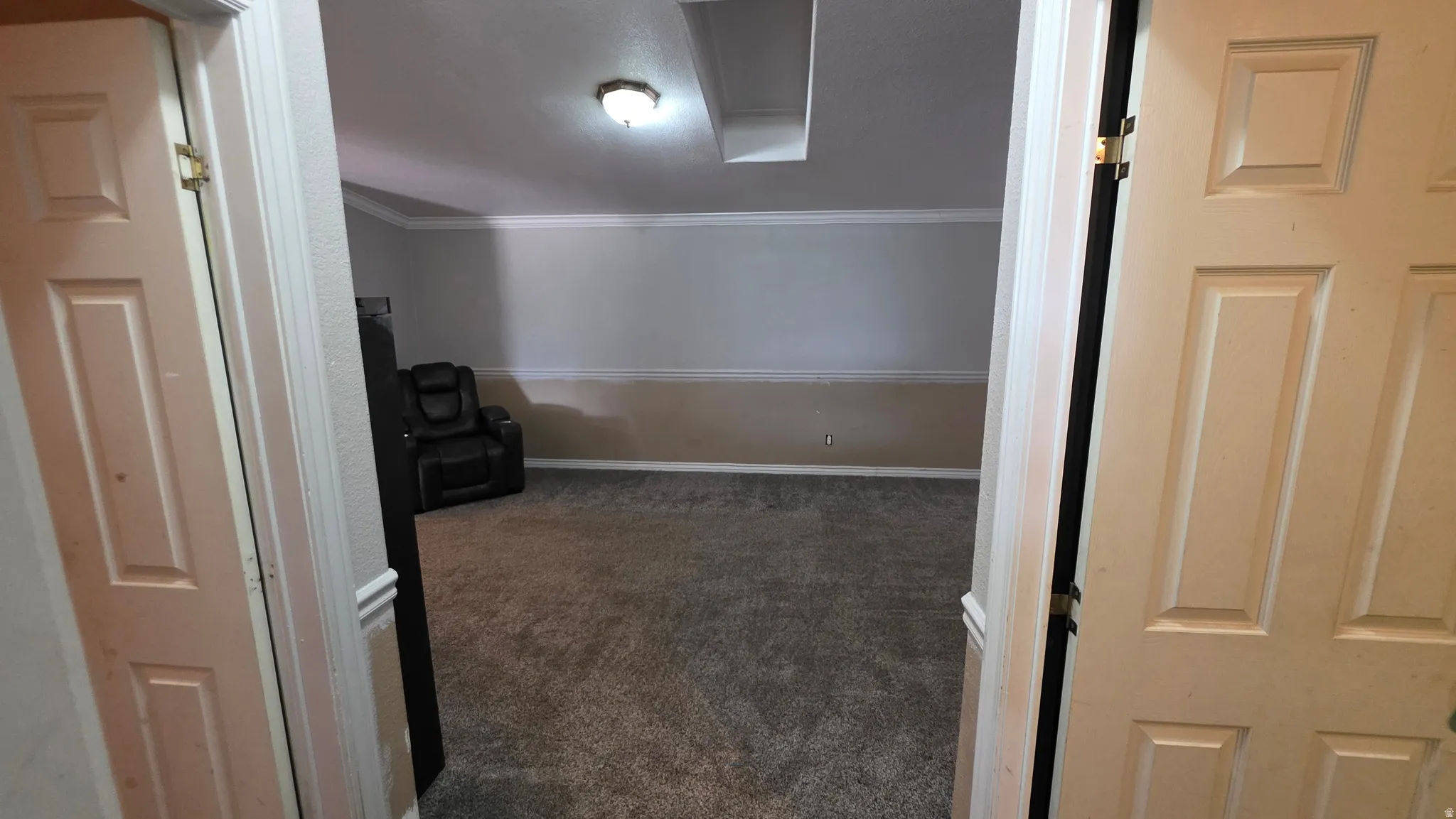 Carpeted flooring, vaulted ceiling, crown molding, and recessed lighting