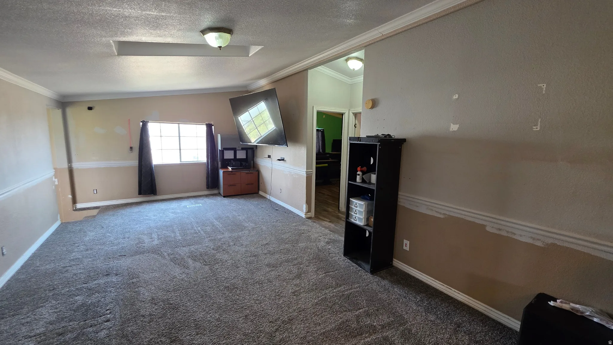 Recessed lighting and ceiling-mounted light fixture illuminate the room