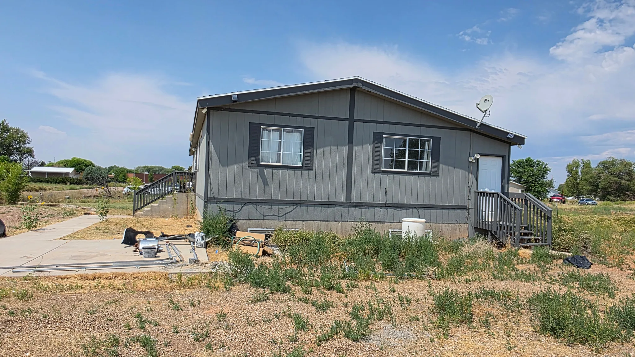 Gray exterior siding with white trim and white-framed windows