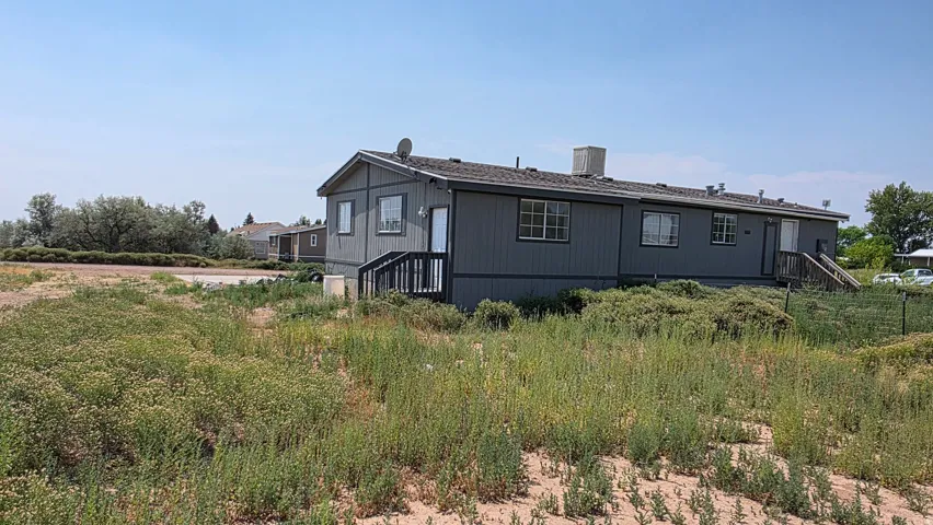 Gray exterior siding with white trim