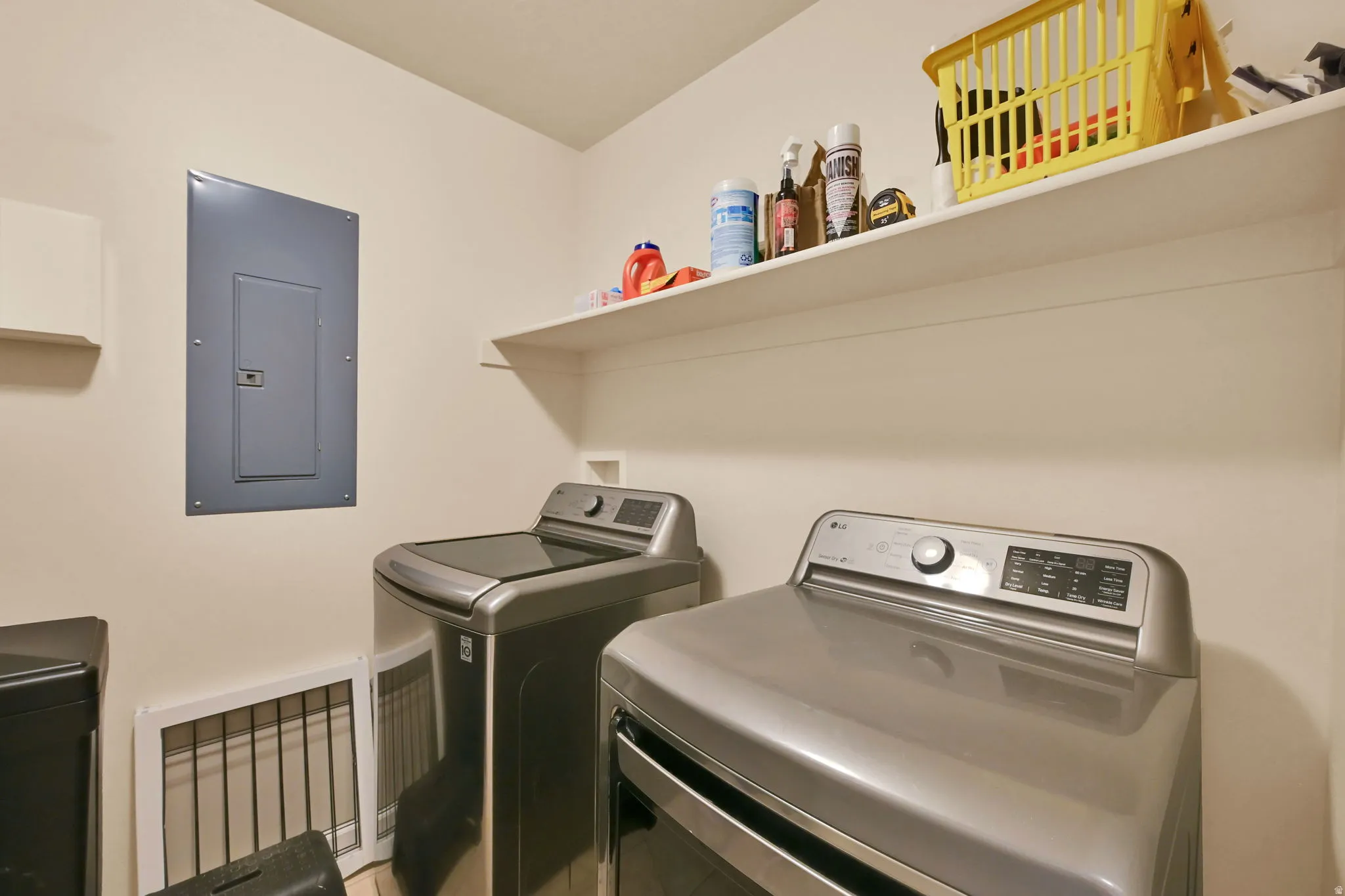 Laundry area featuring a built-in shelf and light-toned walls