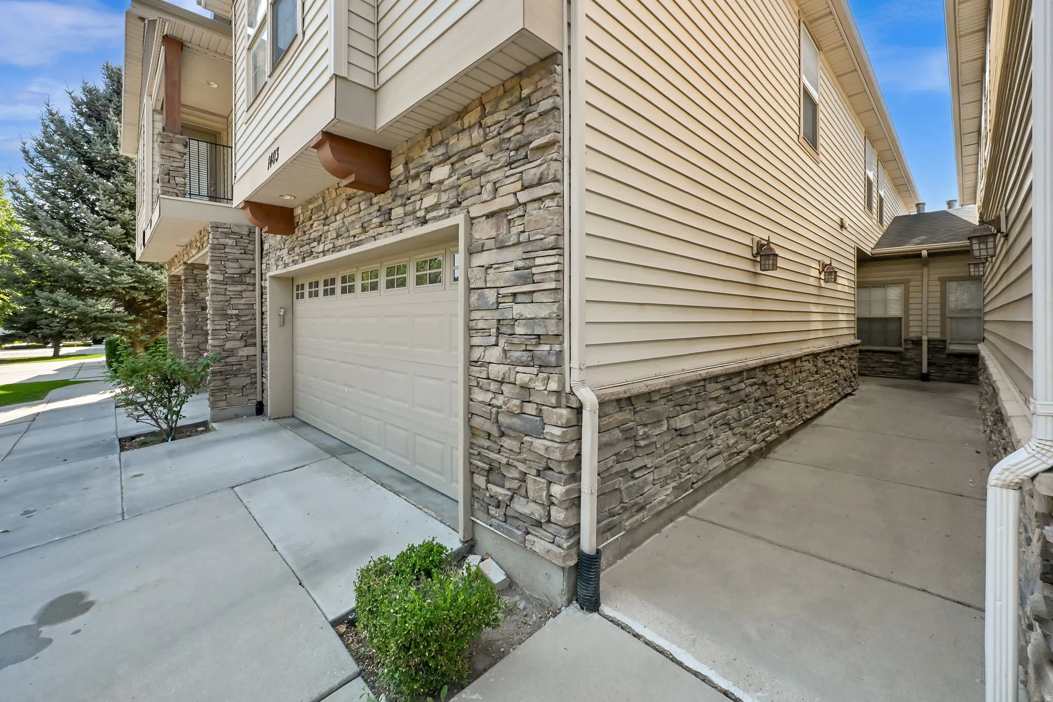 Stone veneer and siding exterior with an integrated garage
