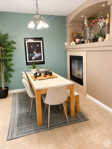 Built-in fireplace with a tiled surround, recessed shelving, and integrated lighting