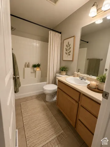 Bathroom featuring a vanity with a light wood finish, integrated sink, and a light-toned countertop