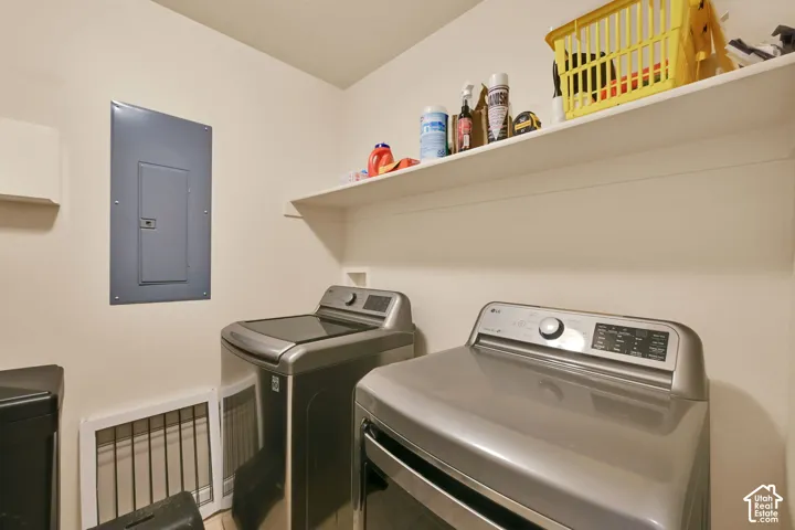 Laundry area featuring a built-in shelf and light-toned walls