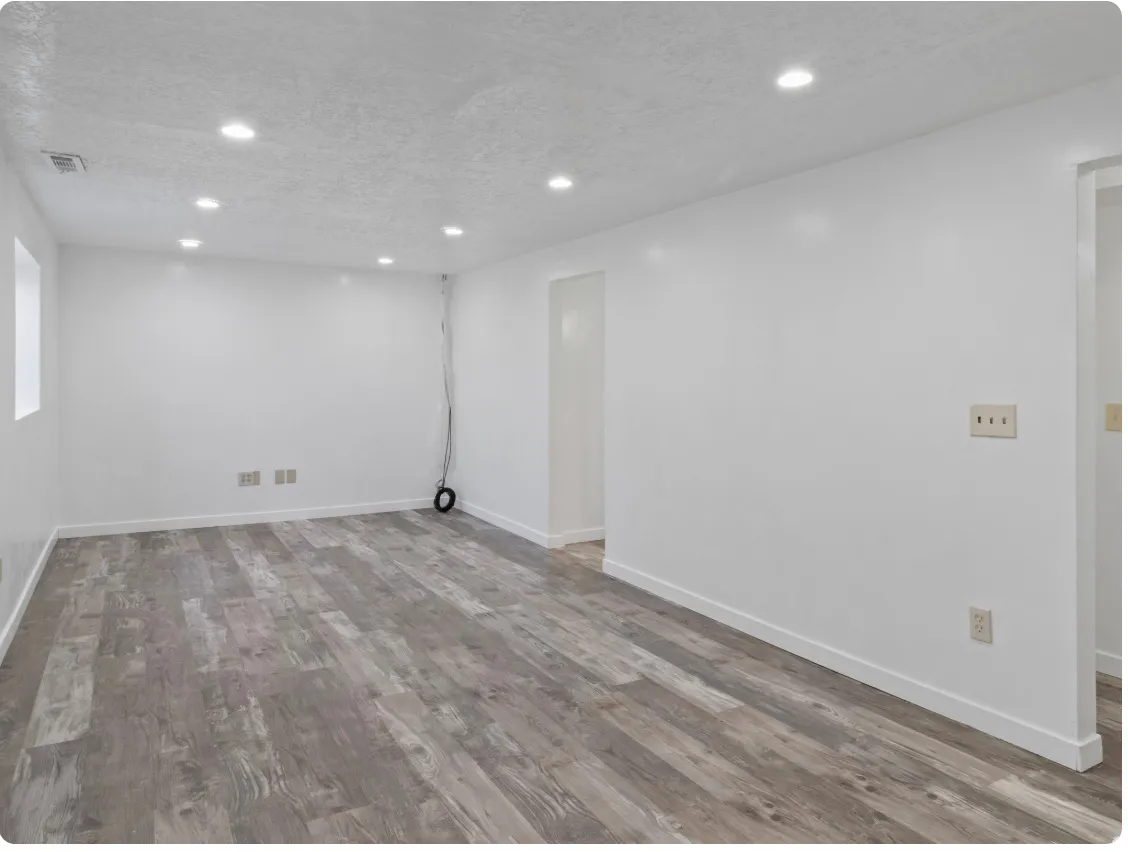 Recessed lighting illuminates the wood-finish flooring