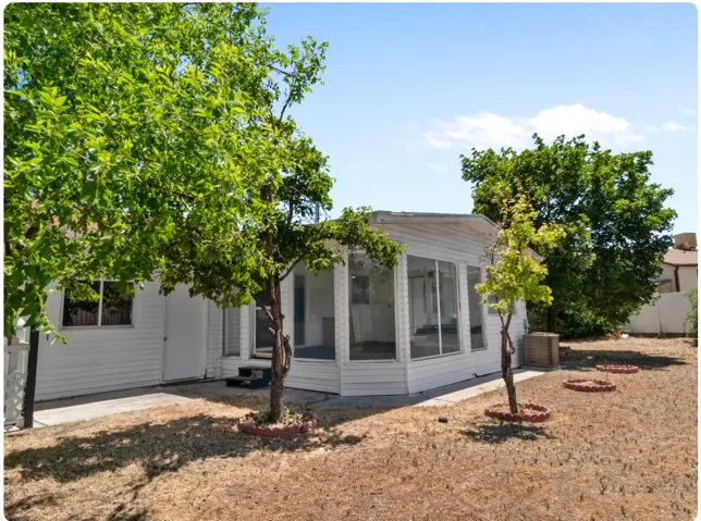 Screened porch with multiple windows, leading to an exterior door