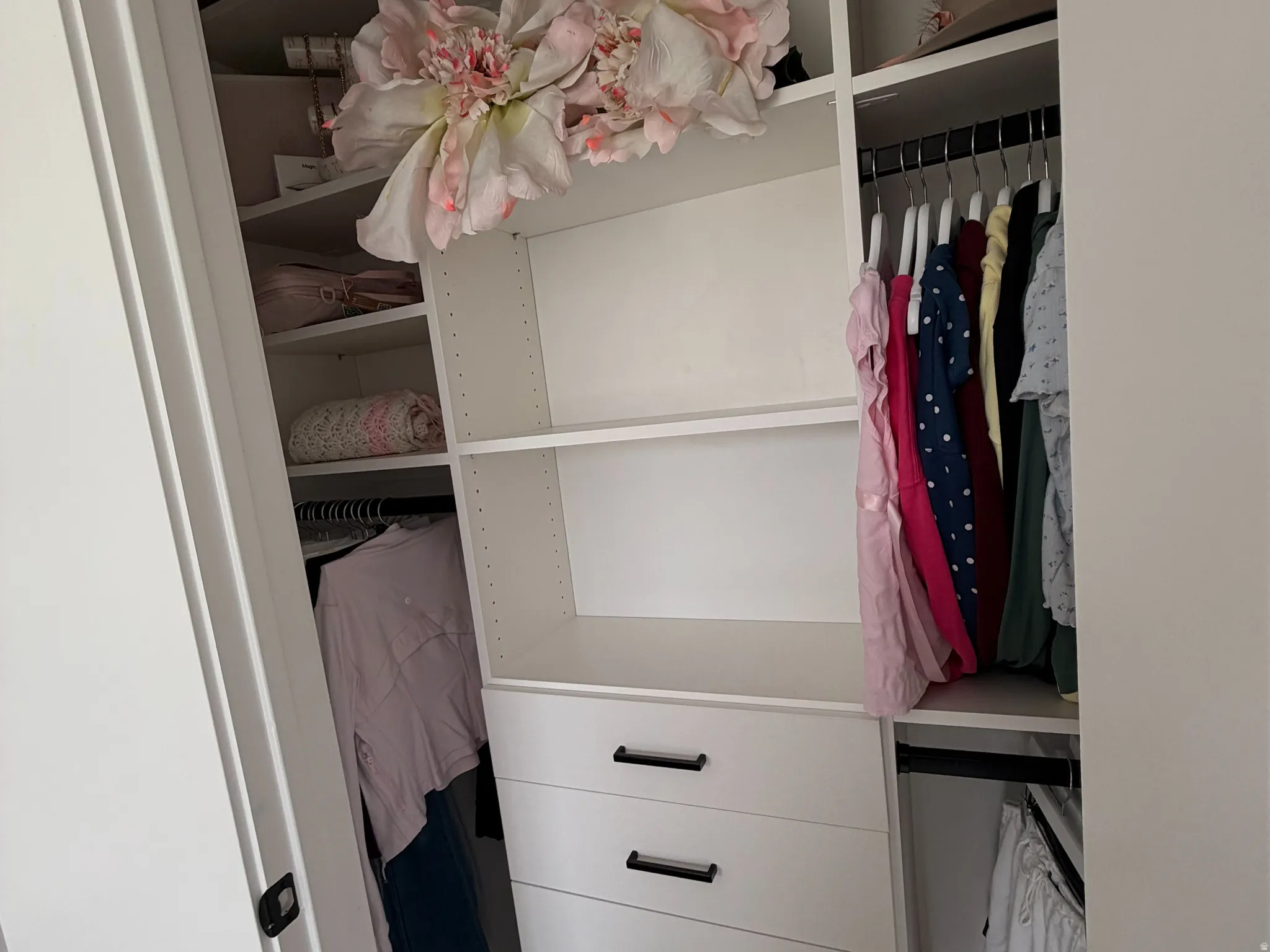 Built-in closet system with shelving, integrated drawers, and hanging rods