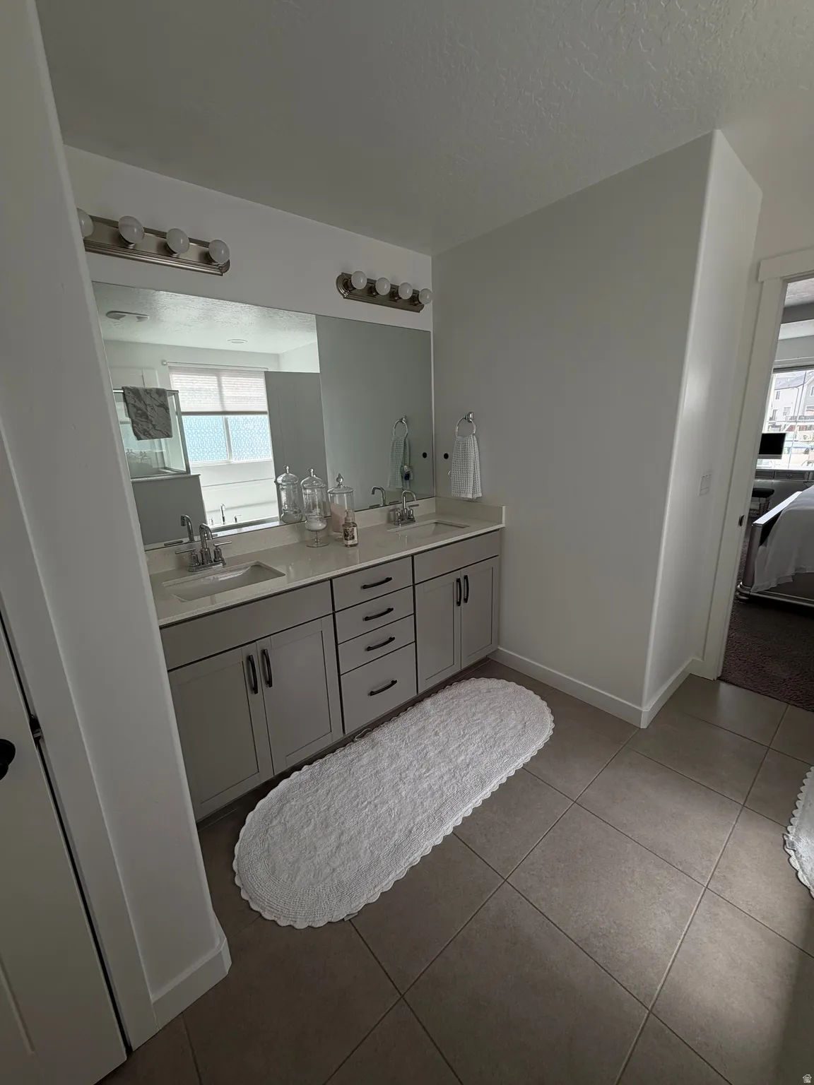 Dual vanity with undermount sinks, gray shaker-style cabinetry, and brushed nickel hardware