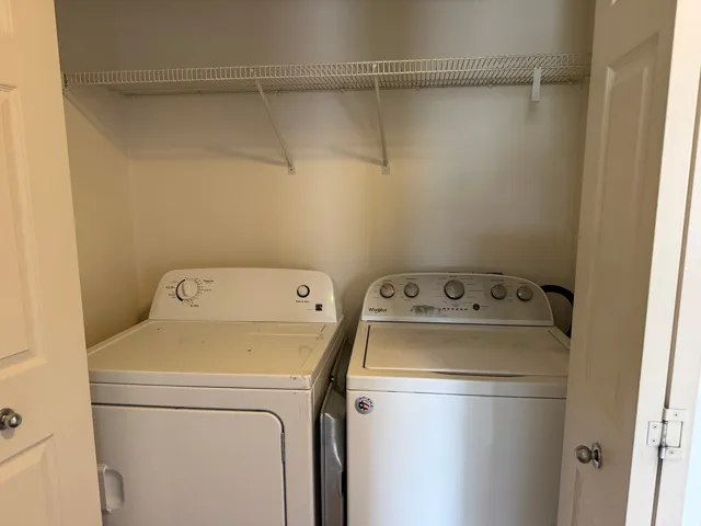 Laundry closet with a white wire shelf