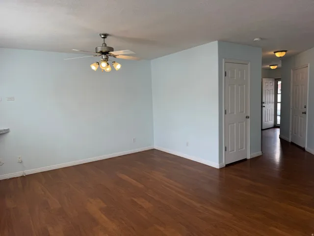 Wood-finish flooring throughout, complemented by a ceiling fan with integrated lighting