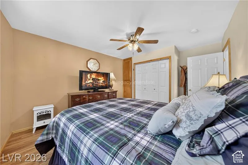 Wood-finish flooring with a ceiling fan light fixture