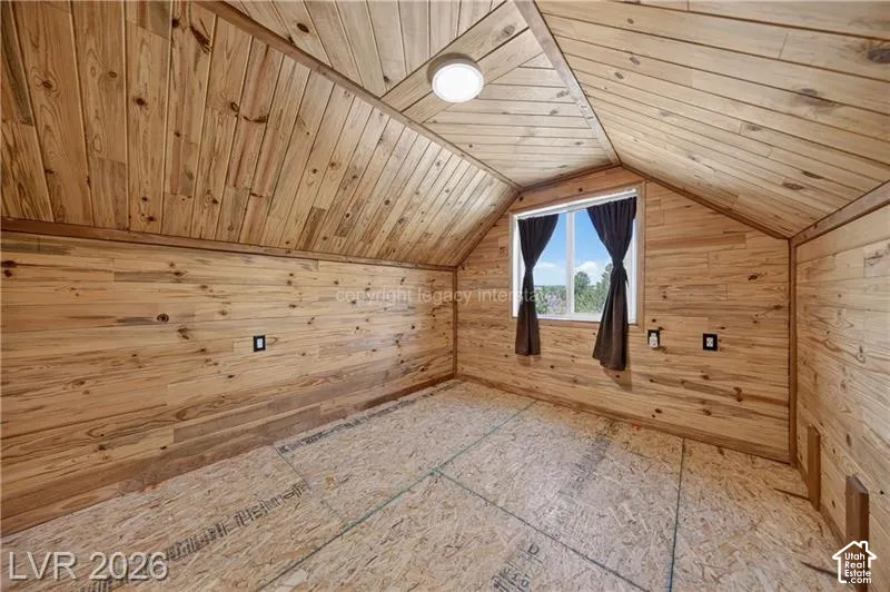 Tongue-and-groove wood paneling, sloped wood-paneled ceiling, recessed window, flush-mount ceiling light