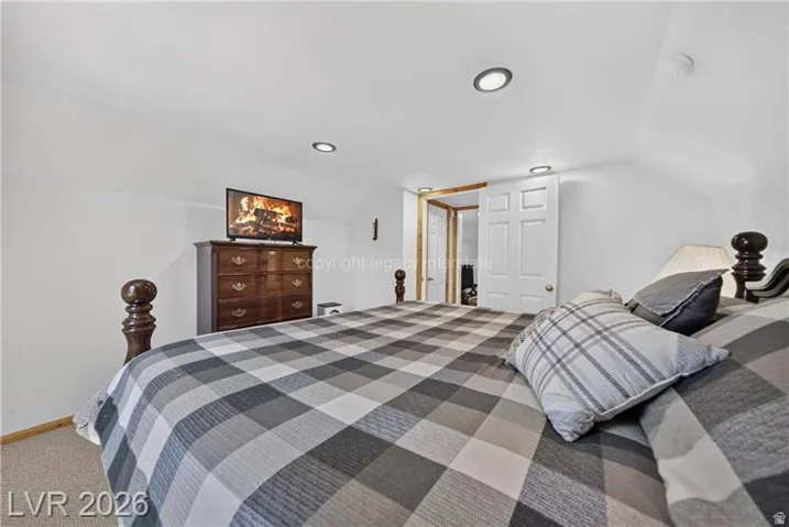 Recessed lighting fixtures, sloped ceiling, white paneled door