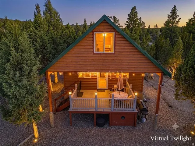 Wood-sided dwelling with a green metal roof and an elevated front porch