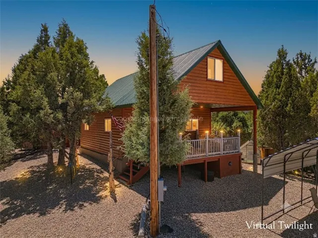 Log cabin style exterior with a green metal roof