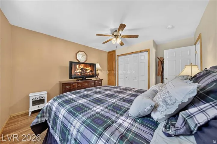 Wood-finish flooring with a ceiling fan light fixture