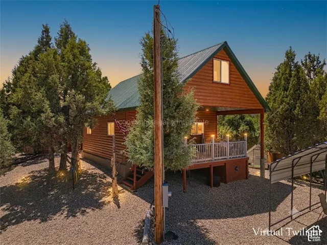Log cabin style exterior with a green metal roof