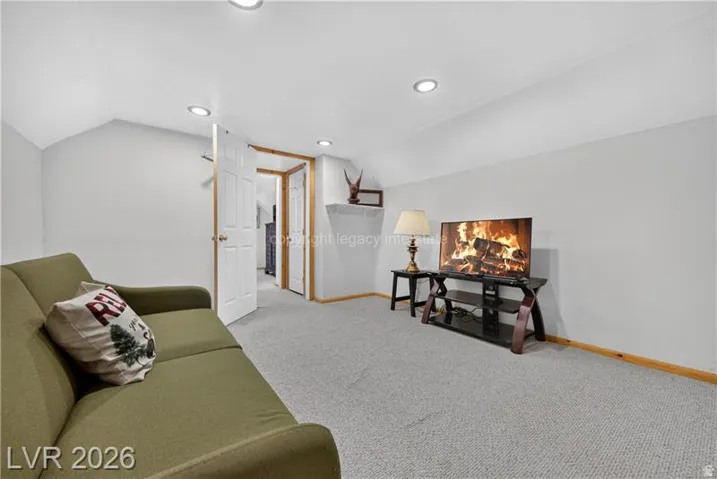 Recessed ceiling lighting, white interior doors, and light gray wall paint
