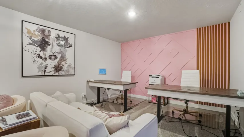 Wall paneling with geometric pattern, recessed lighting, and carpeted flooring