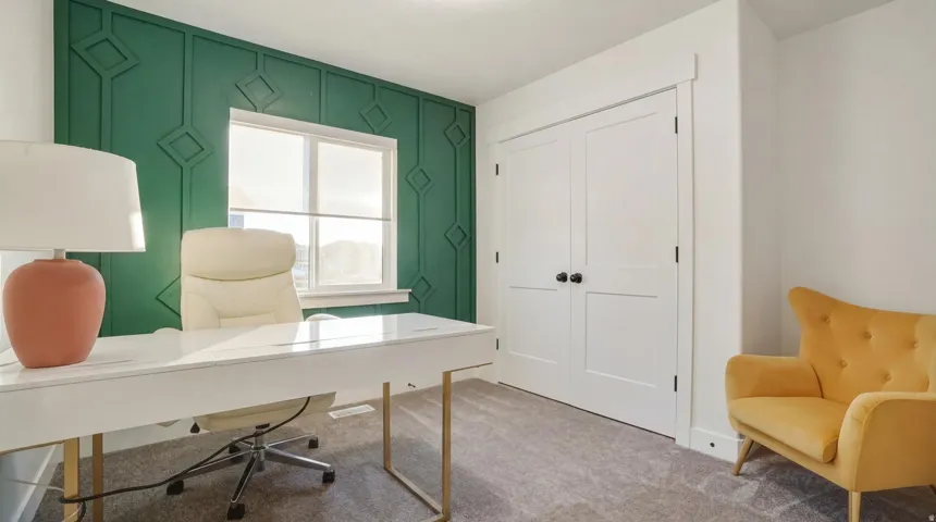 Accent wall with geometric paneling, double-pane window, and white interior doors with black hardware