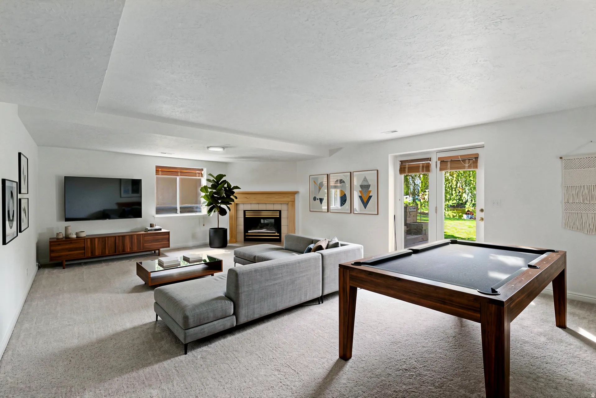 Virtually Staged, spacious living area featuring a fireplace with a wood mantel, glass-paneled patio doors, and recessed lighting