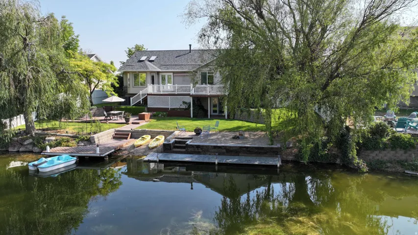 Waterside property with two private docks, a tiered patio, and a spacious deck