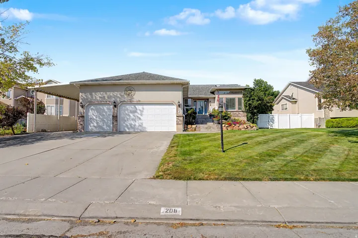 3 Car garage with huge Covered RV pad, Stucco exterior with stone accents and expansive driveway